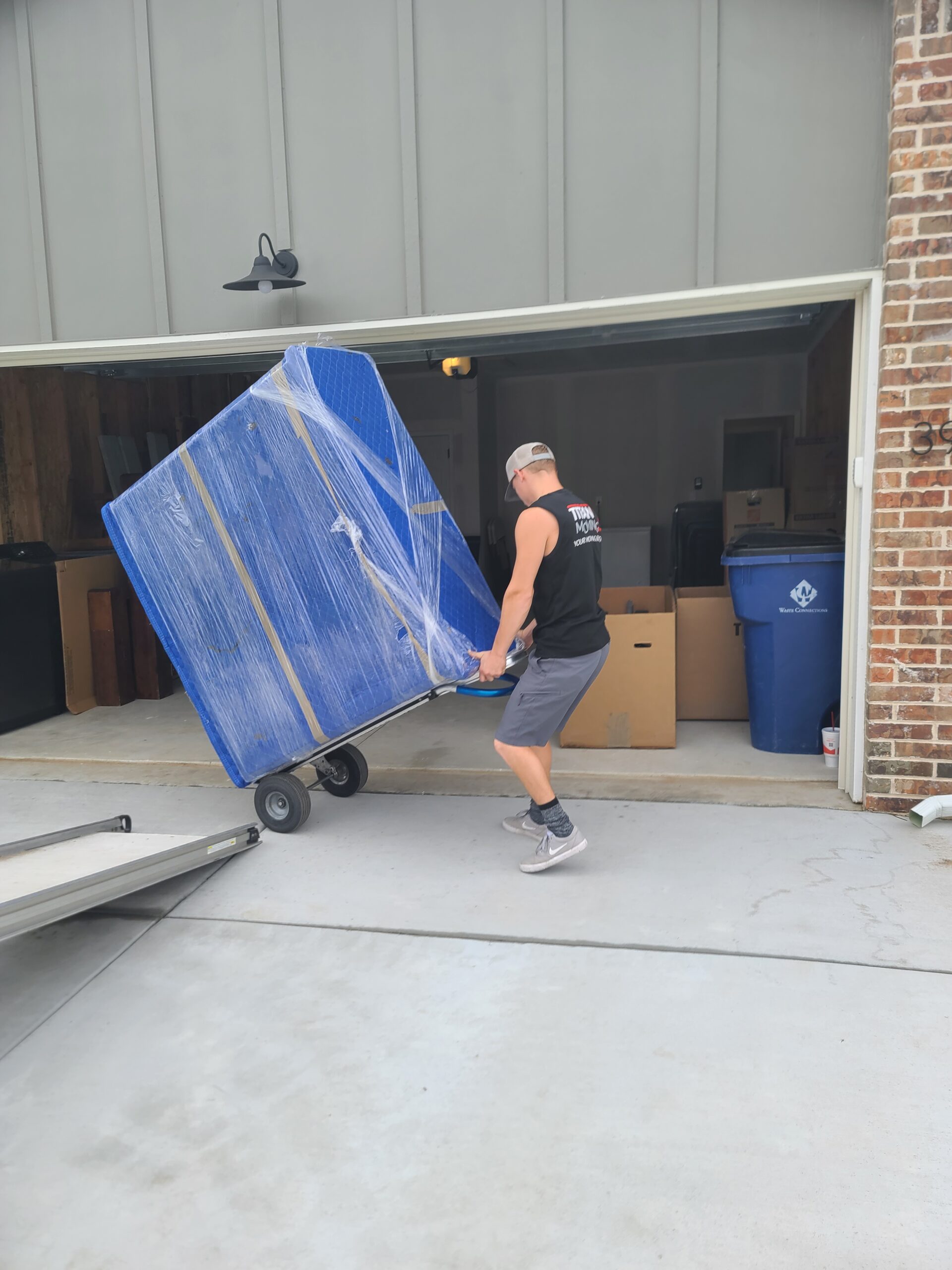 Movers in Andover KS: Titan Moving crew member carefully transporting furniture.
